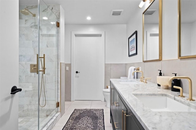 bathroom with tile patterned floors, visible vents, a sink, and a stall shower