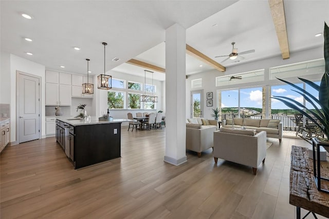 298 Smoke Tree Cir, Dripping Springs, TX 78620 - living area featuring light wood-style floors, beamed ceiling, ceiling fan, and recessed lighting