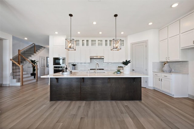298 Smoke Tree Cir, Dripping Springs, TX 78620 - kitchen with appliances with stainless steel finishes, backsplash, white cabinetry, light countertops, and recessed lighting
