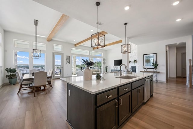 298 Smoke Tree Cir, Dripping Springs, TX 78620 - kitchen with a chandelier, open floor plan, light wood-style floors, beamed ceiling, and recessed lighting