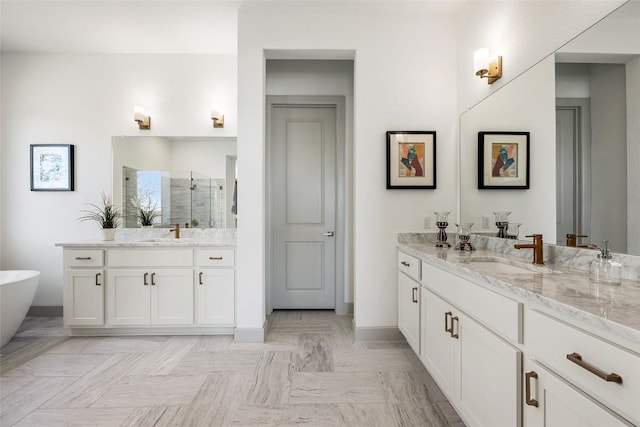 298 Smoke Tree Cir, Dripping Springs, TX 78620 - full bath featuring a stall shower, two vanities, and a freestanding tub