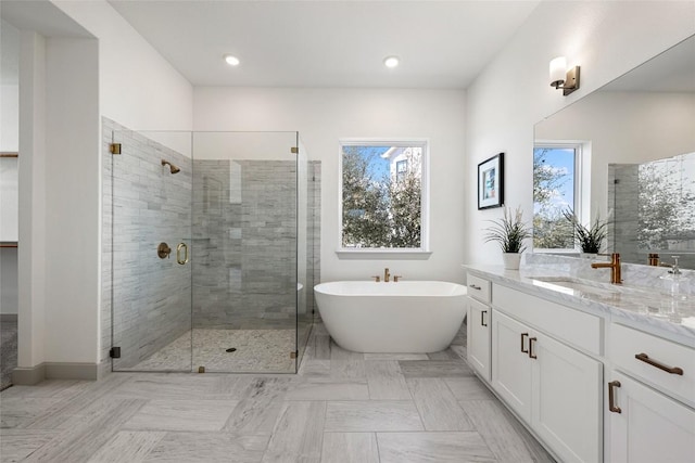 298 Smoke Tree Cir, Dripping Springs, TX 78620 - full bathroom with vanity, plenty of natural light, a stall shower, a soaking tub, and recessed lighting