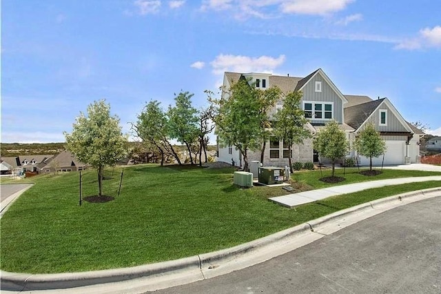 298 Smoke Tree Cir, Dripping Springs, TX 78620 - view of property's community with driveway, a lawn, and an attached garage