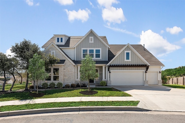 298 Smoke Tree Cir, Dripping Springs, TX 78620 - view of front of property featuring stone siding, driveway, board and batten siding, a garage, and a front lawn