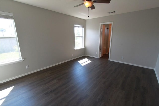 122 Bayliss St, Hutto, TX 78634 - unfurnished room with baseboards, visible vents, ceiling fan, and dark wood-style flooring