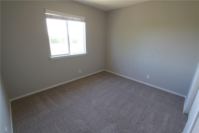 122 Bayliss St, Hutto, TX 78634 - spare room featuring dark colored carpet and baseboards