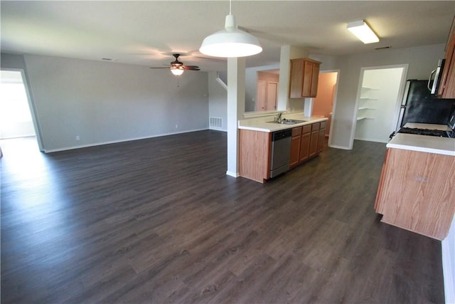 122 Bayliss St, Hutto, TX 78634 - kitchen featuring dark wood-style flooring, a ceiling fan, light countertops, baseboards, and appliances with stainless steel finishes