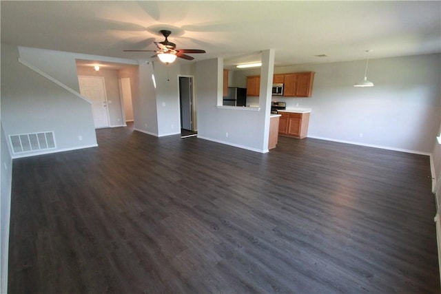 122 Bayliss St, Hutto, TX 78634 - unfurnished living room with dark wood-type flooring, visible vents, a ceiling fan, and baseboards