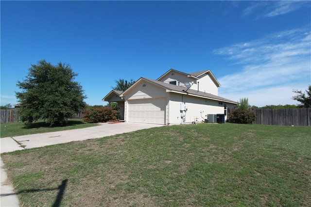 122 Bayliss St, Hutto, TX 78634 - view of front of home featuring central AC unit, fence, a front lawn, and an attached garage