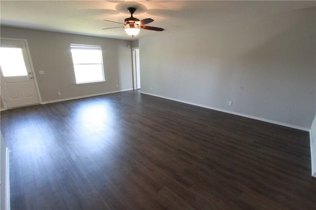 122 Bayliss St, Hutto, TX 78634 - spare room featuring baseboards, a ceiling fan, and dark wood-style floors