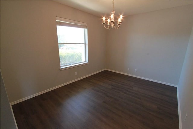 122 Bayliss St, Hutto, TX 78634 - empty room with baseboards, a notable chandelier, and dark wood finished floors
