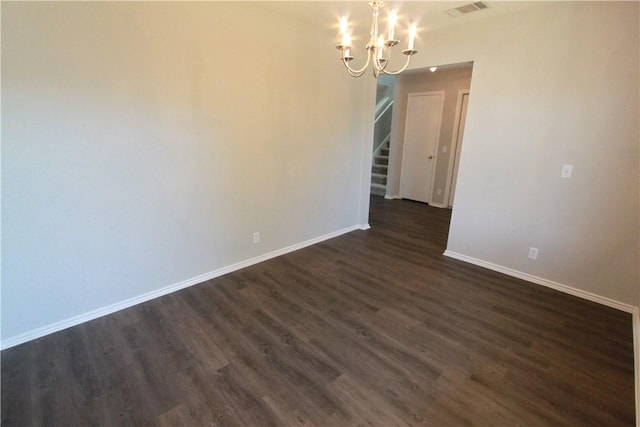 122 Bayliss St, Hutto, TX 78634 - spare room featuring visible vents, baseboards, dark wood-style flooring, and an inviting chandelier