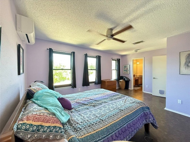 8112 Cache Dr, Austin, TX 78749 - bedroom with a wall mounted air conditioner, a textured ceiling, baseboards, a ceiling fan, and ensuite bathroom