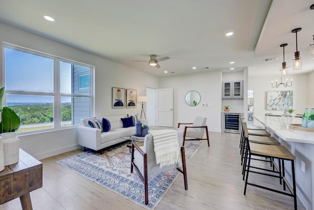 4300 Mansfield Dam Ct Unit 1231, Austin, TX 78734 - living area featuring beverage cooler, a chandelier, baseboards, light wood-type flooring, and recessed lighting