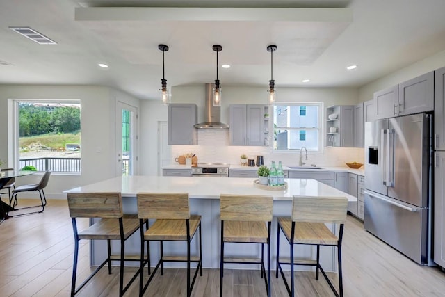 4300 Mansfield Dam Ct Unit 1231, Austin, TX 78734 - kitchen with appliances with stainless steel finishes, gray cabinets, wall chimney range hood, tasteful backsplash, and recessed lighting