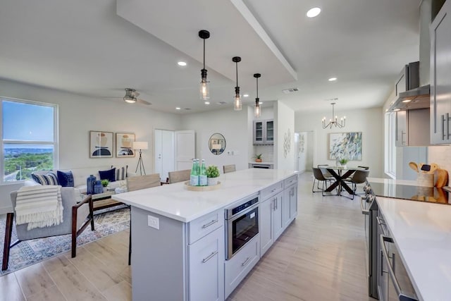 4300 Mansfield Dam Ct Unit 1231, Austin, TX 78734 - kitchen featuring a center island, a breakfast bar, a chandelier, recessed lighting, and light wood-type flooring