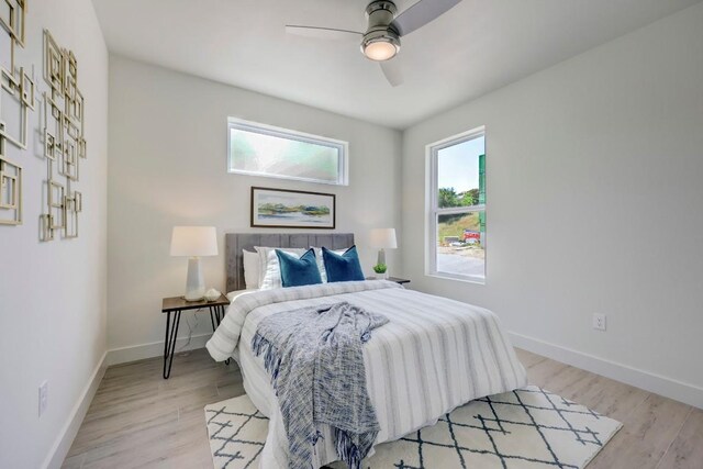 4300 Mansfield Dam Ct Unit 1231, Austin, TX 78734 - bedroom with baseboards, light wood-style floors, and ceiling fan