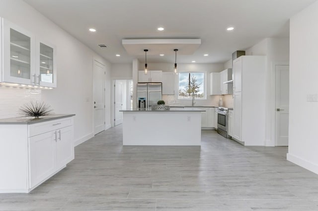 4300 Mansfield Dam Ct Unit 1231, Austin, TX 78734 - kitchen featuring stainless steel appliances, decorative backsplash, white cabinets, recessed lighting, and glass insert cabinets