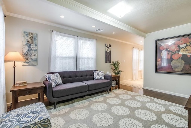 living area featuring plenty of natural light, wood finished floors, and ornamental molding
