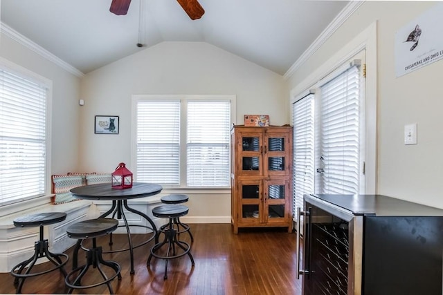dining room featuring a healthy amount of sunlight, dark wood-style floors, ceiling fan, and wine cooler