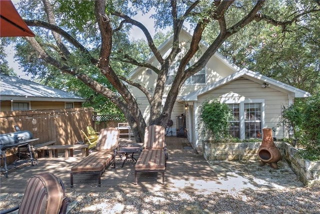 exterior space featuring grilling area and fence