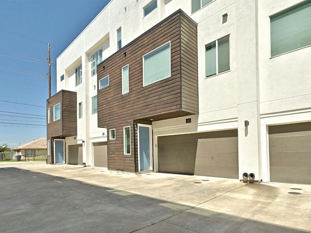 505 Tillery St Unit 6, Austin, TX 78702 - view of building exterior with an attached garage and driveway