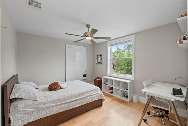 bedroom with light wood-style flooring, visible vents, and ceiling fan