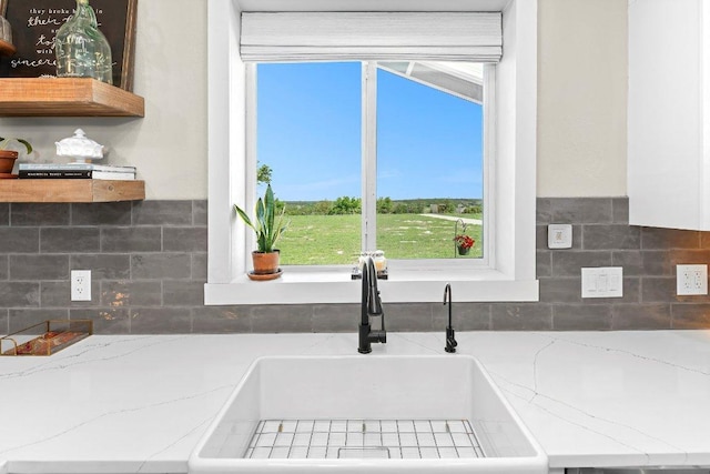 7993 W Fm 487, Florence, TX 76527 - kitchen featuring plenty of natural light, backsplash, and light stone countertops