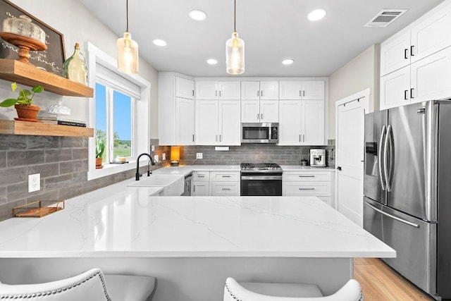 7993 W Fm 487, Florence, TX 76527 - kitchen featuring stainless steel appliances, a peninsula, recessed lighting, light stone counters, and decorative backsplash