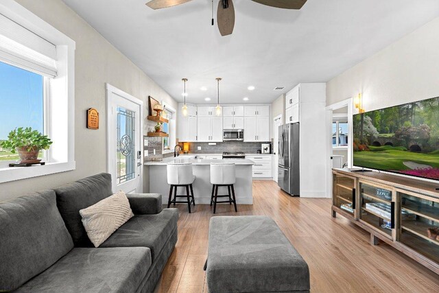 7993 W Fm 487, Florence, TX 76527 - living area with light wood-style flooring, ceiling fan, and recessed lighting
