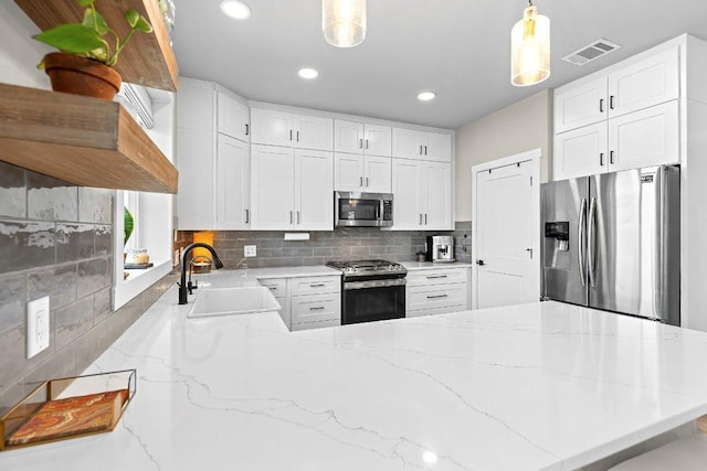 7993 W Fm 487, Florence, TX 76527 - kitchen featuring stainless steel appliances, a peninsula, backsplash, recessed lighting, and hanging light fixtures