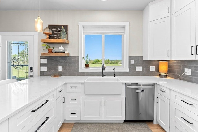 7993 W Fm 487, Florence, TX 76527 - kitchen with stainless steel dishwasher, white cabinets, open shelves, light stone countertops, and decorative backsplash