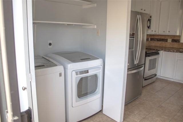 2201 Lakeway Blvd Unit 2, Lakeway, TX 78734 - washroom with washer and dryer and light tile patterned floors