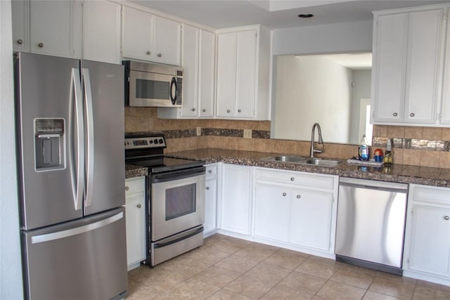 2201 Lakeway Blvd Unit 2, Lakeway, TX 78734 - kitchen featuring stainless steel appliances, tasteful backsplash, and white cabinetry