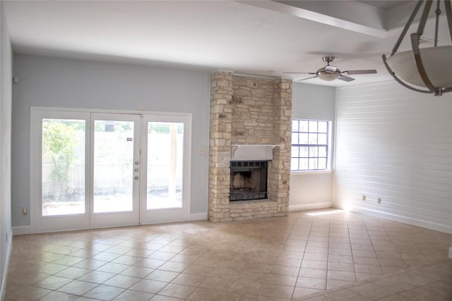 2201 Lakeway Blvd Unit 2, Lakeway, TX 78734 - unfurnished living room with tile patterned floors, a ceiling fan, french doors, and a stone fireplace