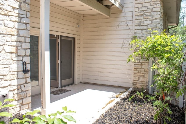 2201 Lakeway Blvd Unit 2, Lakeway, TX 78734 - property entrance with stone siding and a patio area