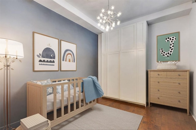 800 W 5th St Unit 1008, Austin, TX 78703 - bedroom with a chandelier, dark wood-type flooring, and a nursery area