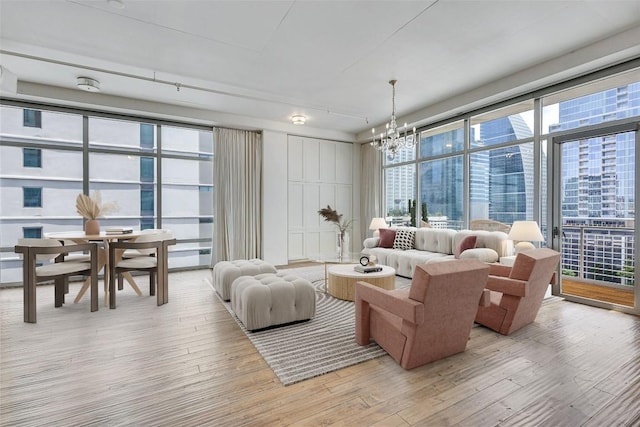 800 W 5th St Unit 1008, Austin, TX 78703 - living area featuring light wood finished floors, a chandelier, and floor to ceiling windows
