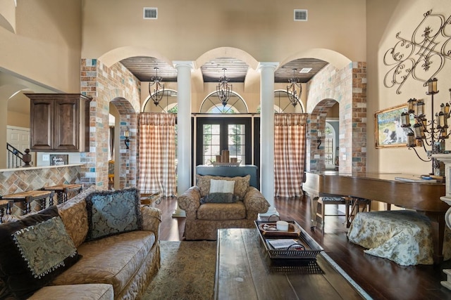 3708 Lajitas, Leander, TX 78641 - living room featuring a high ceiling, wood finished floors, arched walkways, and decorative columns