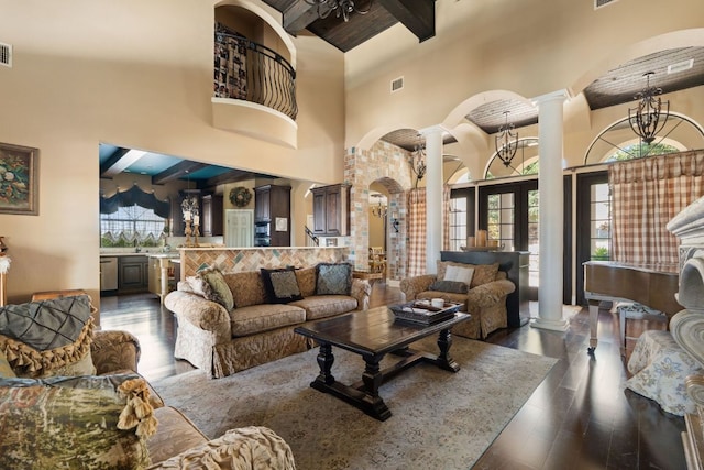 3708 Lajitas, Leander, TX 78641 - living area featuring ornate columns, a towering ceiling, beam ceiling, arched walkways, and dark wood-style flooring