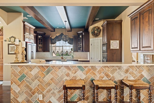 3708 Lajitas, Leander, TX 78641 - kitchen with beamed ceiling, high quality fridge, tasteful backsplash, light countertops, and glass insert cabinets