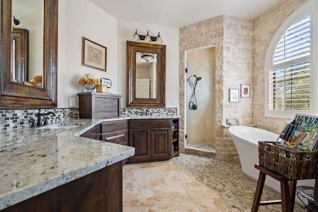 3708 Lajitas, Leander, TX 78641 - bathroom with a shower stall, a freestanding tub, stone tile floors, and two vanities