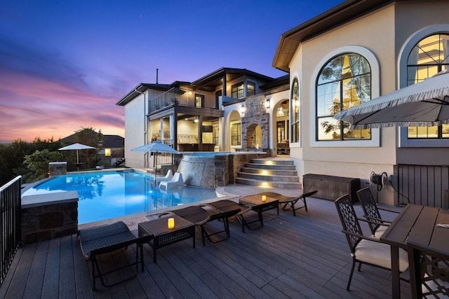 3708 Lajitas, Leander, TX 78641 - pool at dusk with an outdoor pool, a wooden deck, and outdoor dining area