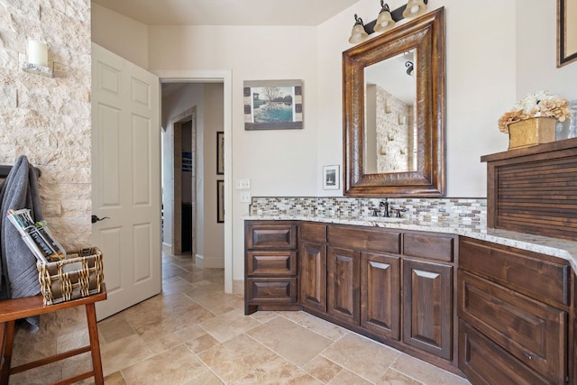 3708 Lajitas, Leander, TX 78641 - bathroom with vanity, backsplash, and stone finish floors