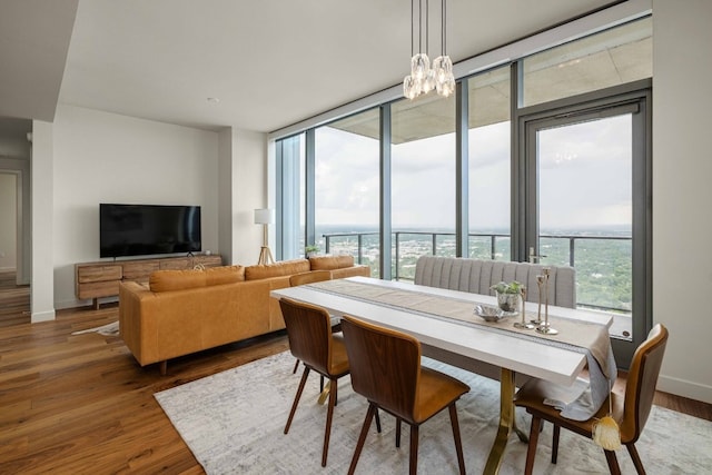44 E Ave Unit 4305, Austin, TX 78701 - dining room featuring wood finished floors and a chandelier