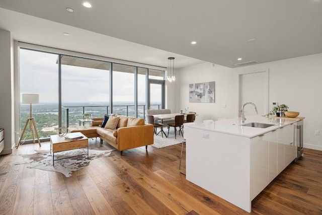 44 E Ave Unit 4305, Austin, TX 78701 - kitchen featuring a sink, white cabinetry, a wall of windows, dark wood-type flooring, and modern cabinets