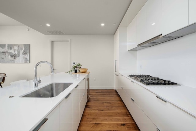 44 E Ave Unit 4305, Austin, TX 78701 - kitchen with a sink, white cabinets, recessed lighting, light countertops, and dark wood-style flooring