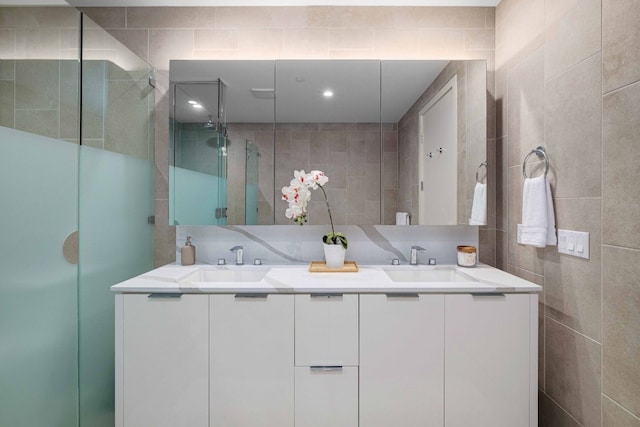 44 E Ave Unit 4305, Austin, TX 78701 - bathroom featuring tile walls, double vanity, and a shower stall