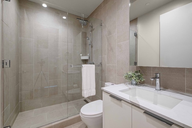 44 E Ave Unit 4305, Austin, TX 78701 - bathroom featuring toilet, vanity, a shower stall, tile walls, and recessed lighting