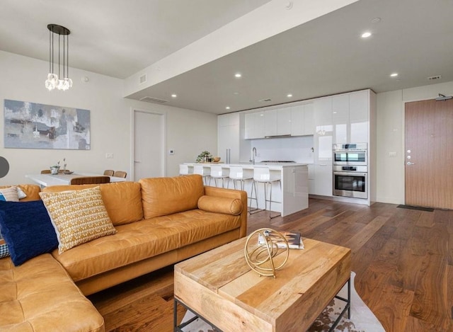 44 E Ave Unit 4305, Austin, TX 78701 - living area featuring dark wood-type flooring and recessed lighting